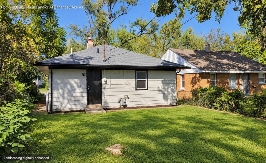 Rear exterior with fresh green lawn