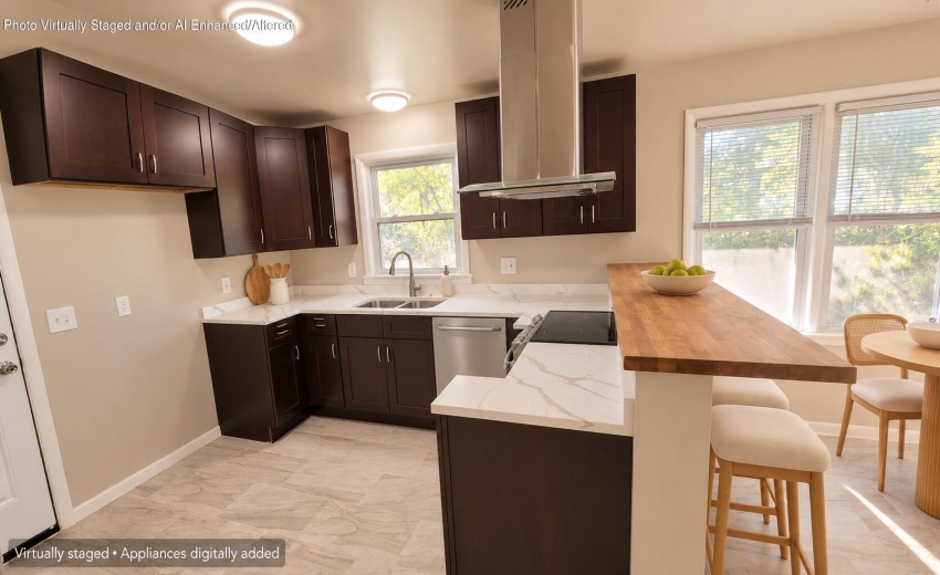 Staged kitchen with breakfast bar and st
