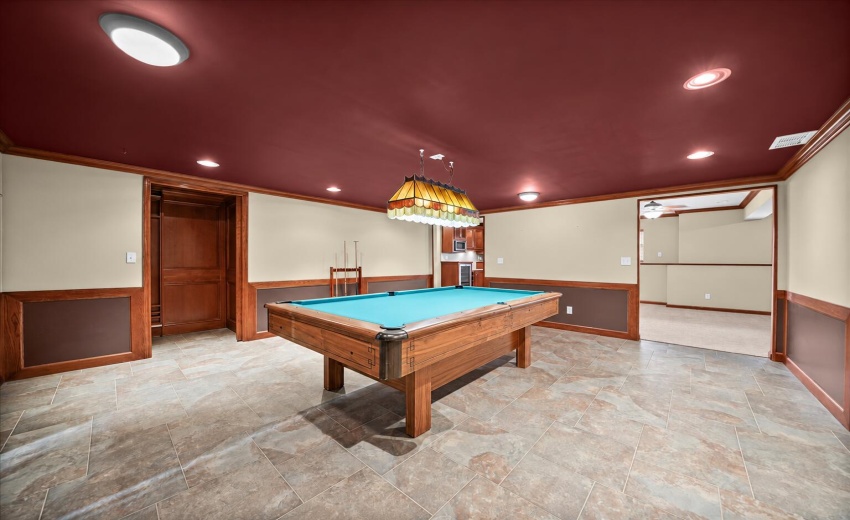Cleared pool table in bright game room