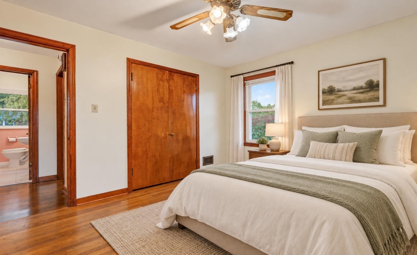 Bright staged bedroom with sage accents