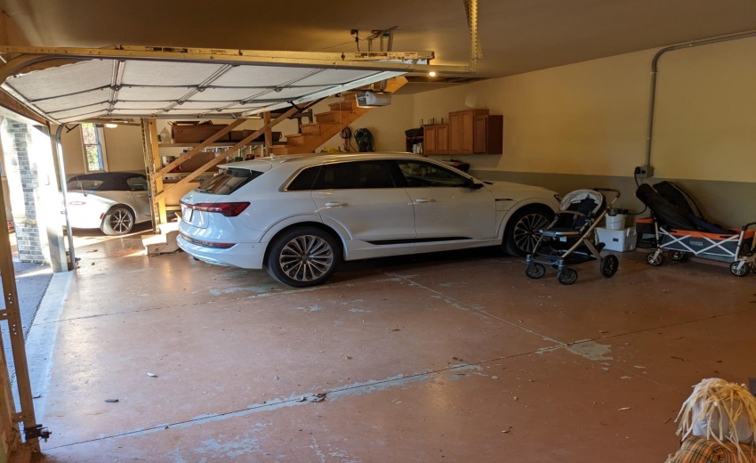 Oversized 3 car with floored storage above. Electric for charging for 2 level 2 cars