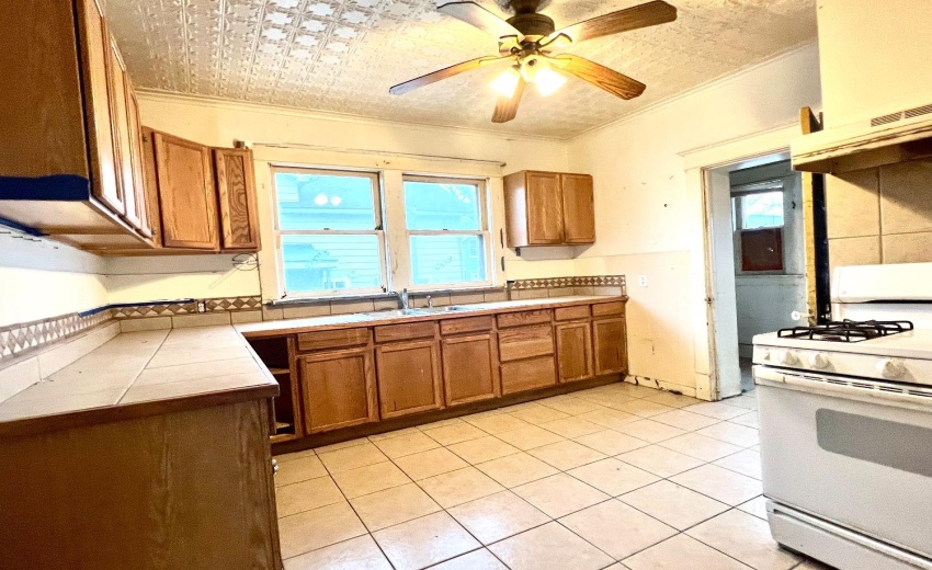 Spacious kitchen off dining room with access to upstairs, and rear pantry/mudroom. Also a convenient closet single toilet room.