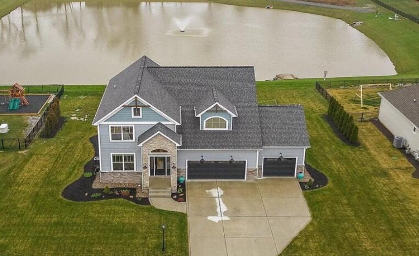 Front Aerial View With Pond