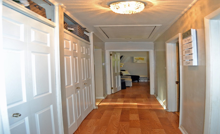 hallway to bedrooms with pull down attic