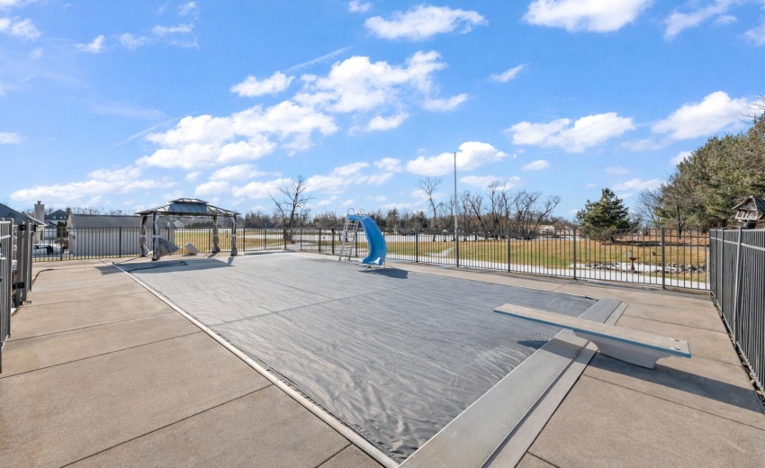 Sunny poolside retreat with blue slide