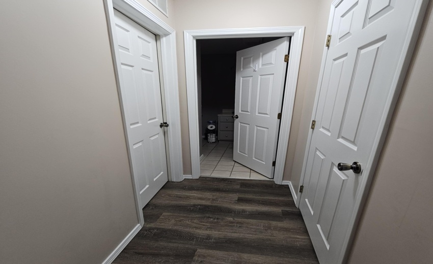 hallway access to utility on left, bath