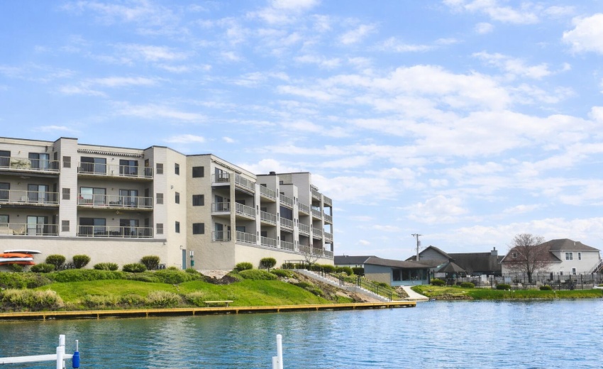 Modern lakeside condominium with lush la