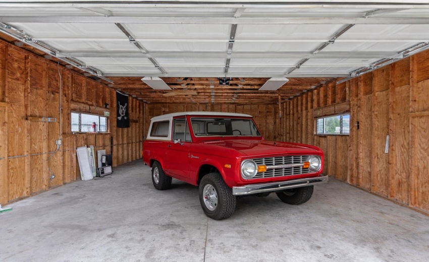 Vintage red Ford Bronco in garage