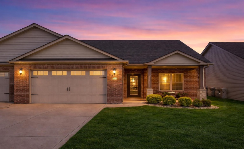 Twilight suburbia with illuminated home