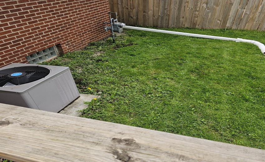 AC unit. Long downspout to keep that wat