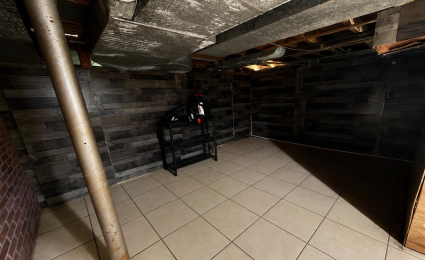 a_wide_angle_view_of_a_dim_unfinished_ba