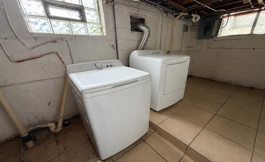 a_wide_angle_photo_of_a_basement_laundry