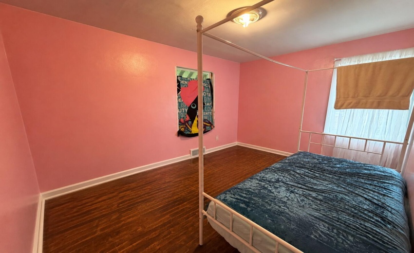 a_wide_angle_photo_of_a_simple_bedroom_i