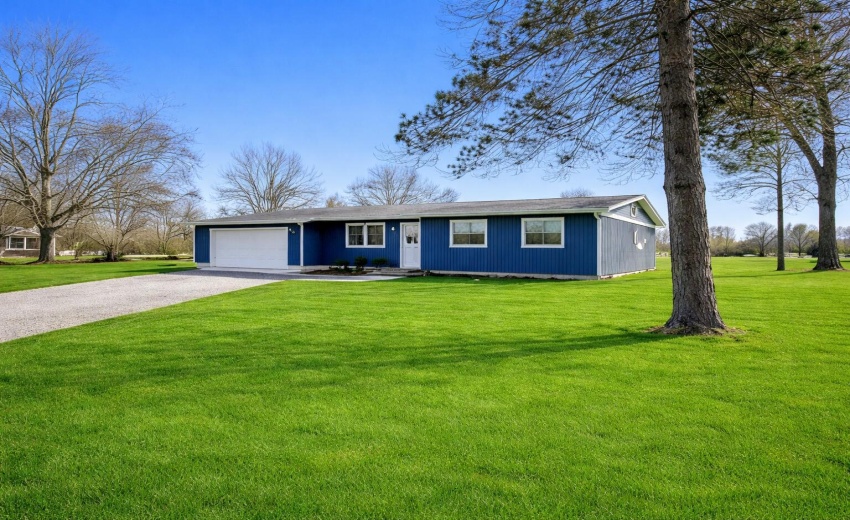Blue ranch house on lush lawn